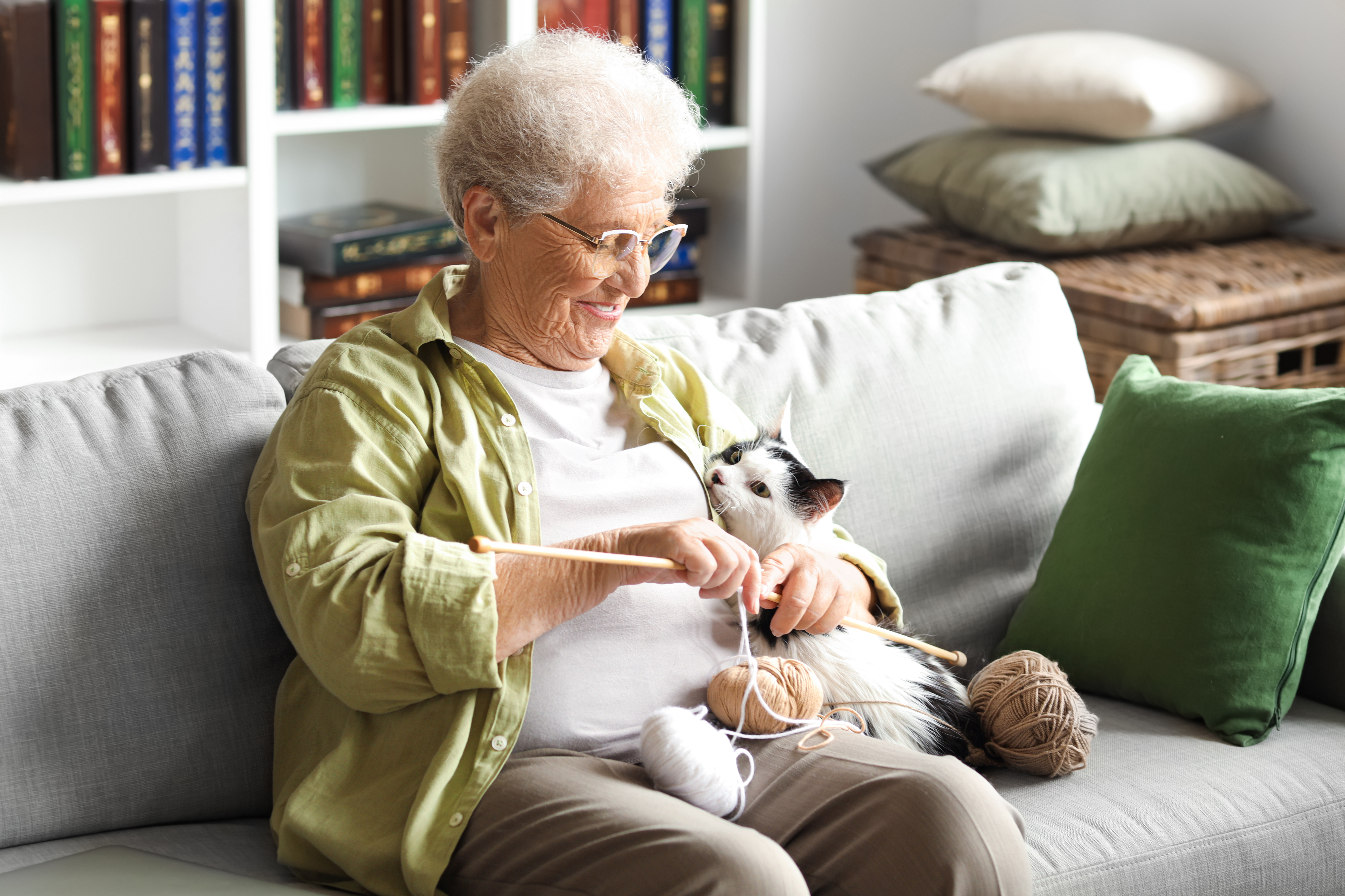 A senior woman resting at home with her cat